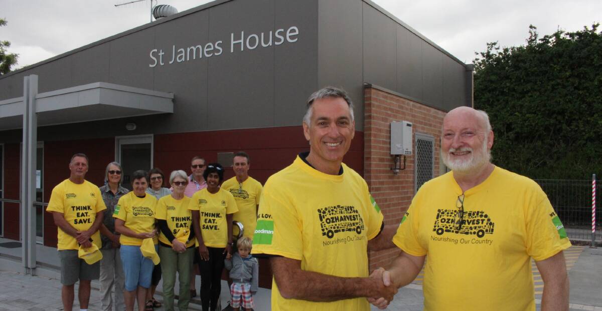 HANDOVER: Reverend Michael Palmer with Peter Buggy and volunteers, as OzHarvest moves into its new home.