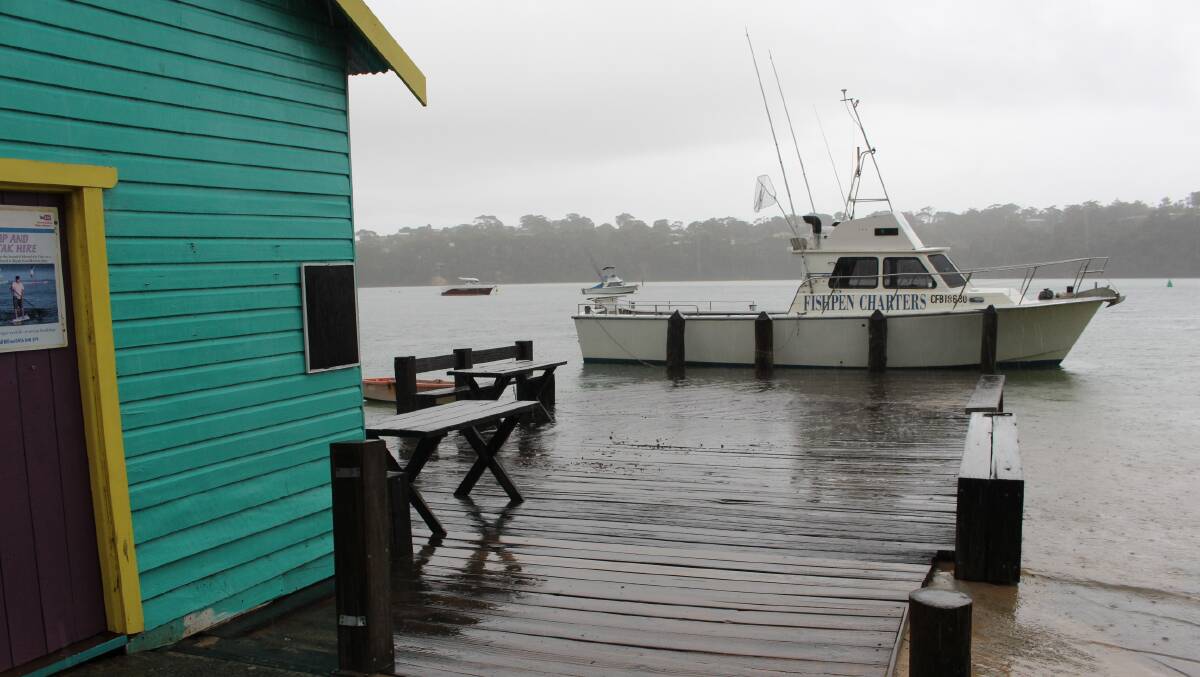 WATERSHED: The combination of continued rainfall over several days and a king tide at Merimbula saw Mitchies Jetty partly under water on Tuesday. 