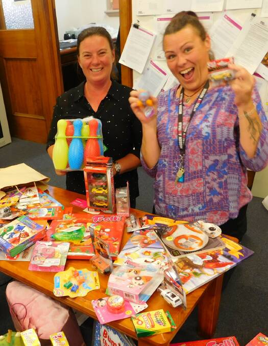 Iona Coleman and Heidi Burke of Mission Australia with some of the toys that have been donated for the Bega Refuge Centre.