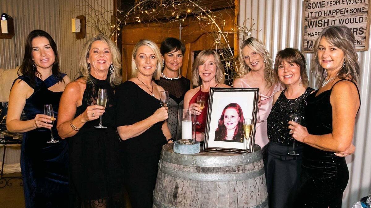 MAD Ball committee members light a candle for Tracey Beasley. From left Jo Furniss, Michelle Collins, Tracy Elton, Michelle Pettigrove, Emily Abbott, Sarah Maguire, Louise Yeoman and Deb Hodkinson. Photo: Daisy Hill Photography