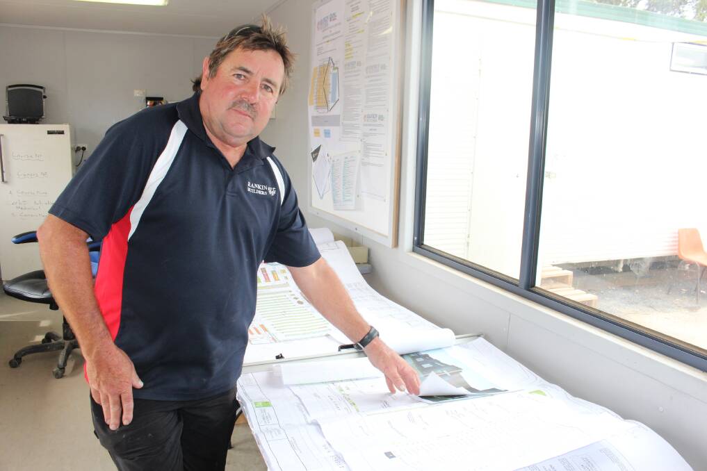 Neil Rankin of Rankin Builders in the site office at the Woolworths development in Main Street, Merimbula. 