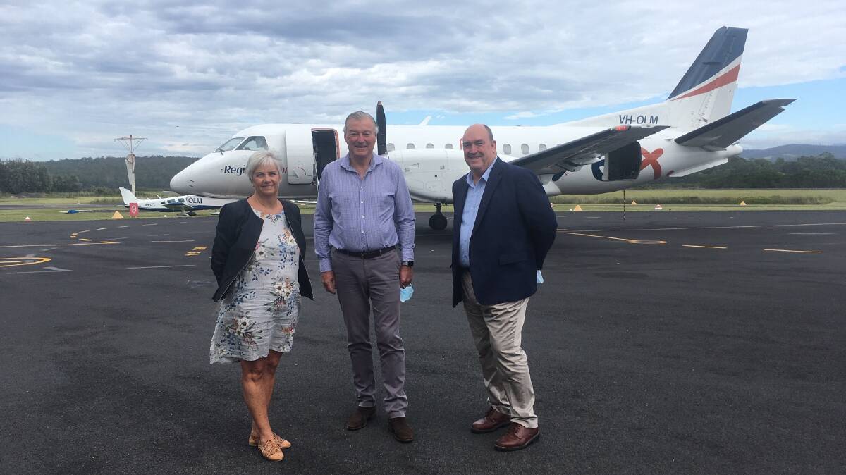 BEARER OF GOOD NEWS: Rex deputy chairman John Sharp (centre) with council's general manager Leanne Barnes and the mayor, Russell Fitzpatrick at Merimbula Airport.