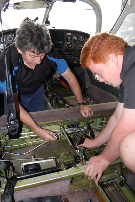 Rex Koerbin and apprentice Tom Burn work on a cable replacement job at Merimbula Aircraft Maintenance.
