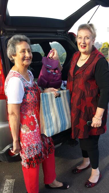 Kathy Keys and Margaret Trianta, of Merimbula's Made by U 9am Gym Girls, loading the car with bags and toiletry items for the Bega Refuge Centre.
