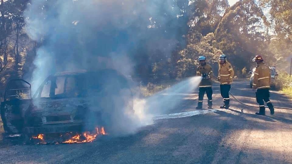 The stolen car being extinguished by Merimbula Rural Fire Service.
