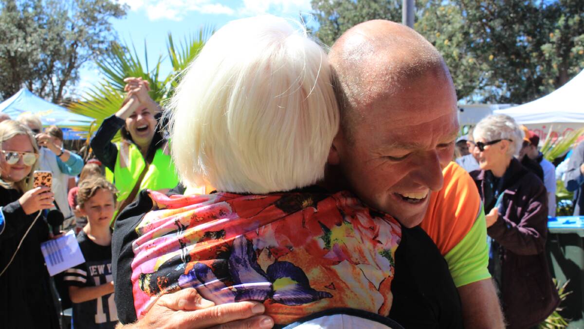 TEAMWORK: A proud moment for Junee Waites as she welcomes son Dane Waites after his 4000km run from Perth to Pambula. 
