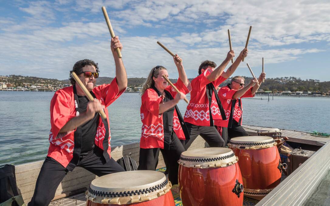 Stonewave Taiko drummers made their way along the Fishpen foreshore on an oyster punt driven by oyster farmer Brett Weingarth. Photo David Rogers
