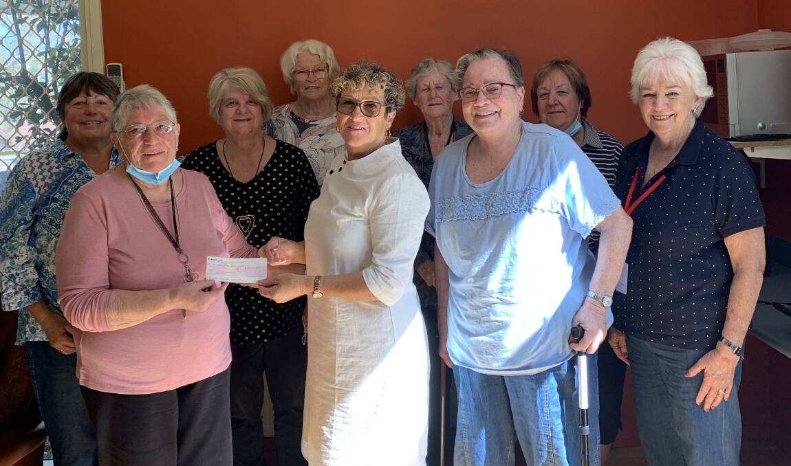 Long-term president of SOHI Sharon Tapscott hands over a cheque to the Pambula Hospital Auxiliary. Picture supplied