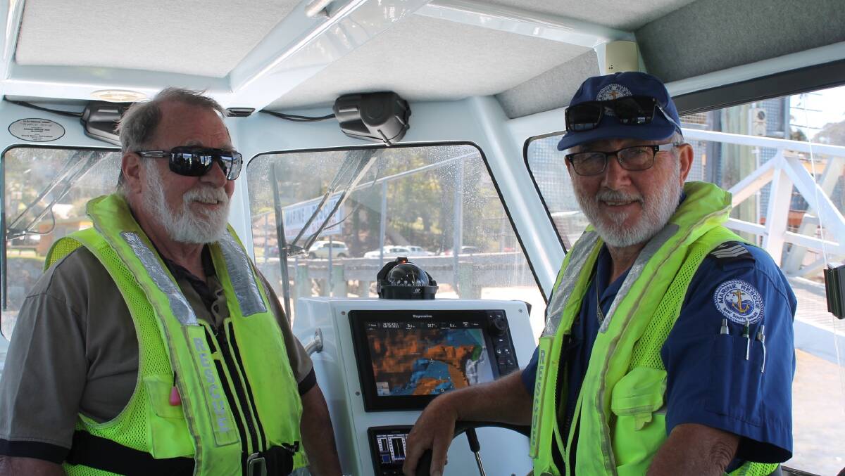 Alan (right) of Merimbula Marine Rescue shares some of the stories of his volunteering with Chris of U3A during an outing to the Marine Rescue bases at Merimbula.