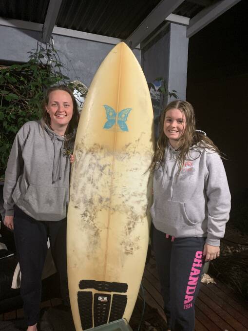Looking for an owner: Grace Roach and Alyssa Mulcahy with the board they found.