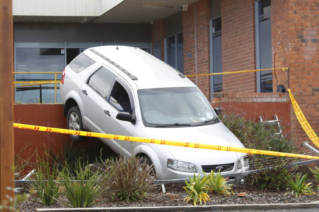 Lucky dive: Driver left unharmed as his car nose dives from the Pambula Medical Centre car park into the dentist's car park . Photo: Rachel Mounsey