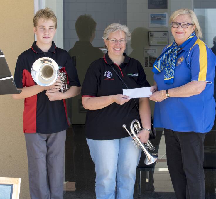 Community support: Jamie Parker-Barnes and Christina Barnes are presented with a cheque from Robyn Bedford from Pambula-Merimbula Lions Club while busking in  Ayres Walkway, Bega.  Picture: Dianne Frazer