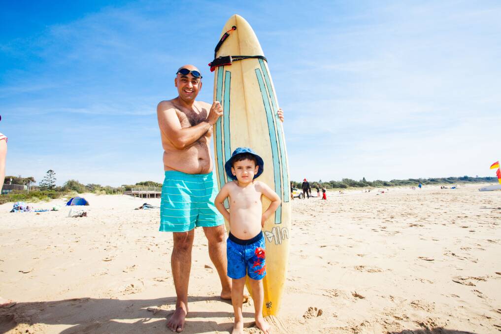 Surfs up : Civil engineer Haytham Alaiek and his 4-year-old son Maher from Syria visited Pambula Beach for the first time over the weekend. Photo: Rachel Mounsey