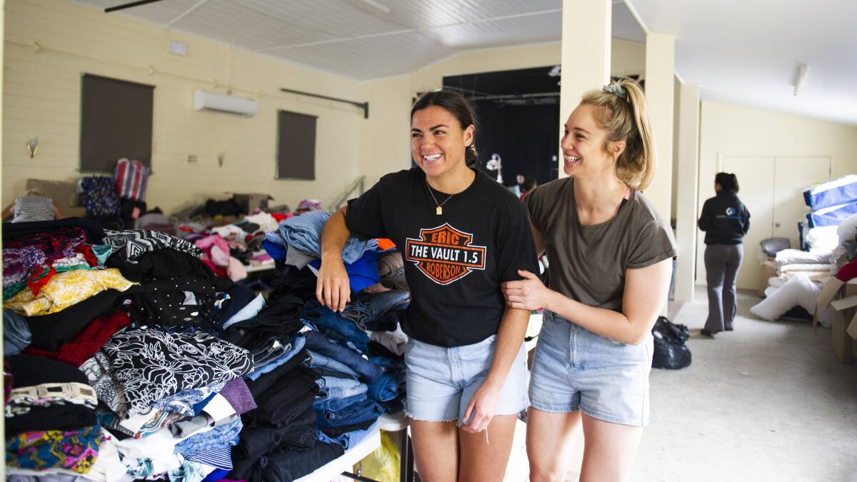 BIG HEARTS: Millie Boyle and Kezie Apps visit Cobargo to support the volunteers sorting out the huge amount of donations. Picture: Dion Georgopoulos 
