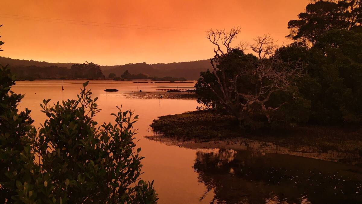 The sky above the Bermagui River glows orange during the recent bushfire emergency. Picture: Caitlin Brown 