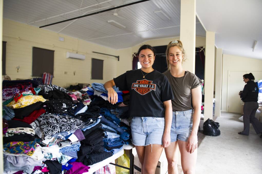 OFFERING SUPPORT: Millie Boyle and Kezie Apps visit Cobargo to support the volunteers sorting out the huge amount of donations. Picture: Dion Georgopoulos 