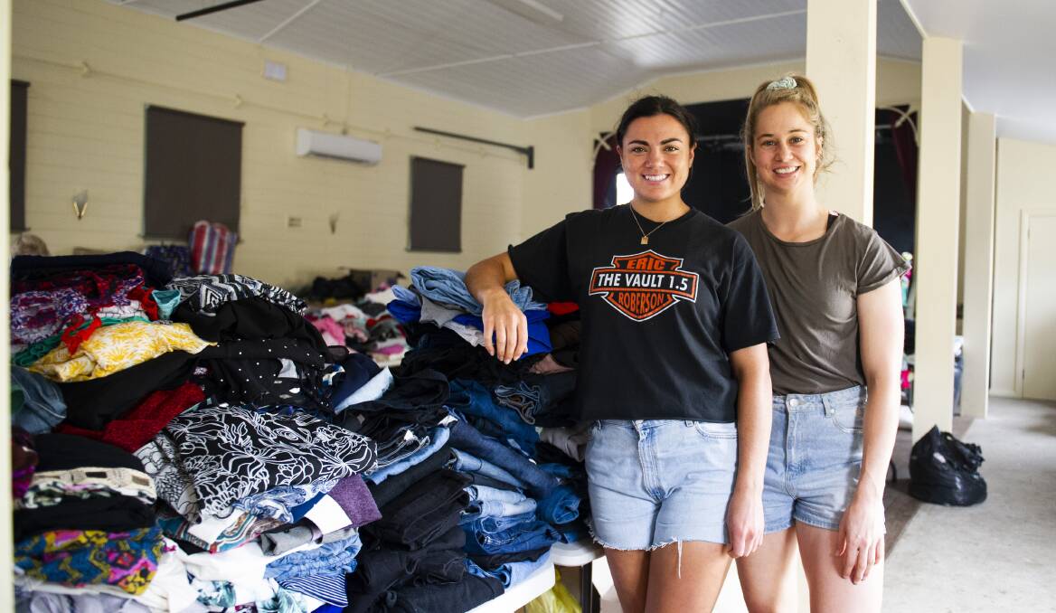 OFFERING SUPPORT: Millie Boyle and Kezie Apps helping sort out the huge amount of donations at Cobargo. Picture: Dion Georgopoulos 