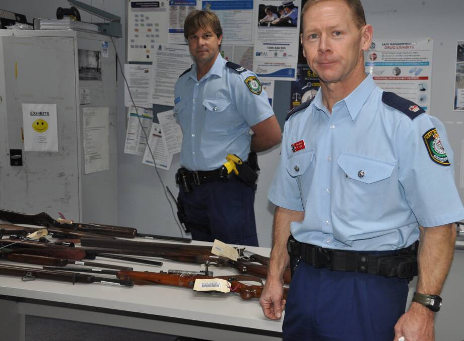 AMNESTY TIME: Chief Inspector Greg Flood and Senior Constable Caine Irwin with firearms surrendered to Batemans Bay Police Station.