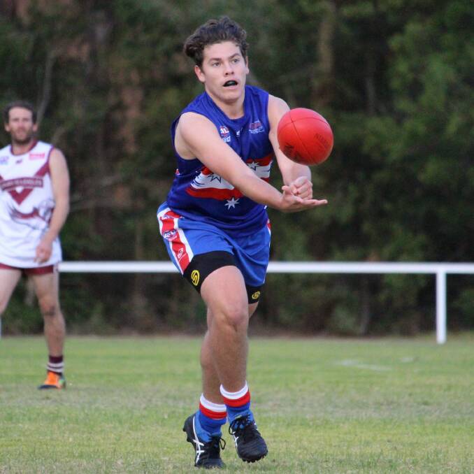 A Merimbula player gets a handball clear during the Diggers' win over the Tathra Sea Eagles on Saturday. Picture Jarrod Moore. 