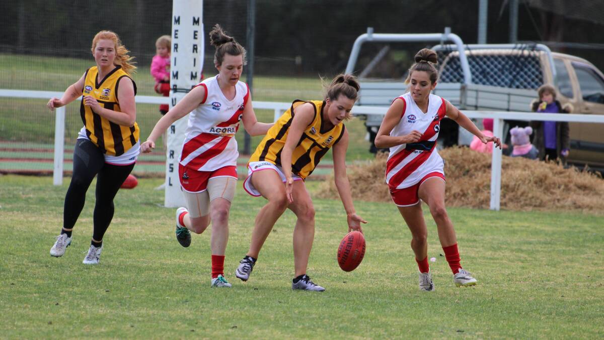 Safe hands: Romy Cook looks to nab the ball as two Whalers players close in during Saturday's preliminary final. 