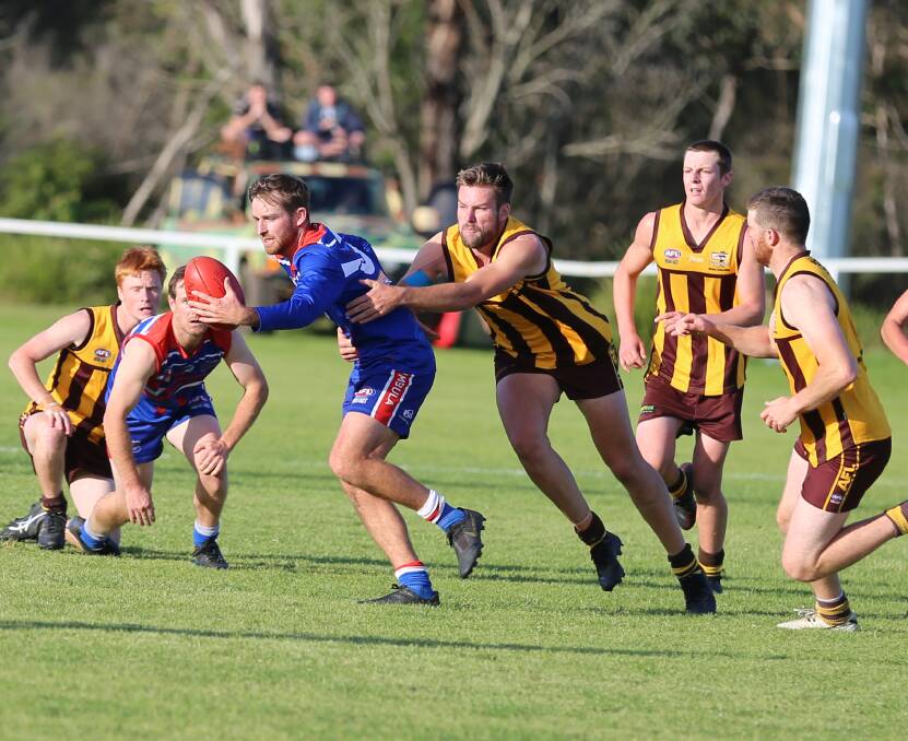Pambula's Kyle Tucker, pictured wrapping up Merimbula on-baller Tom Adams, has been named the 2021 SCAFL senior best and fairest. 