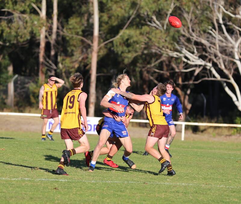 The Diggers and Panthers tussle for the ball during the second quarter of play in their local derby at the Pambula Sporting Complex. 