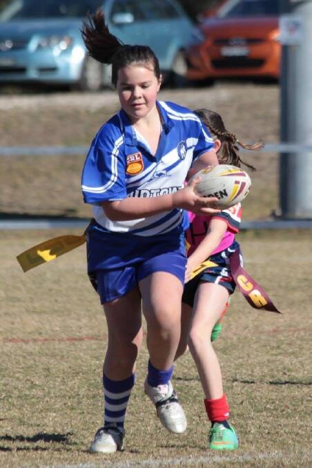 Good run: A junior league-tag Bulldog escapes a tackle attempt by her opponent, with the junior Bulldogs to host a fun day on March 3. 
