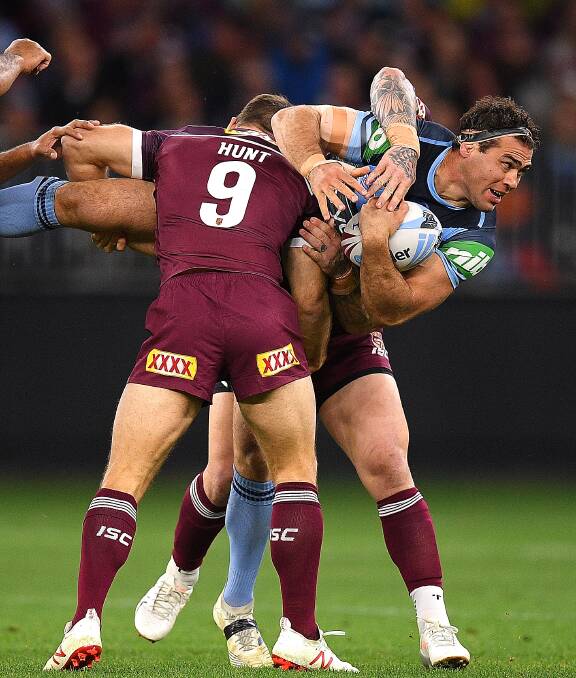 Wrapped up: Felise Kaufusi and Ben Hunt combine in a tackle of Bega rugby league export Dale Finucane in Origin two on Sunday. Picture: AAP. 