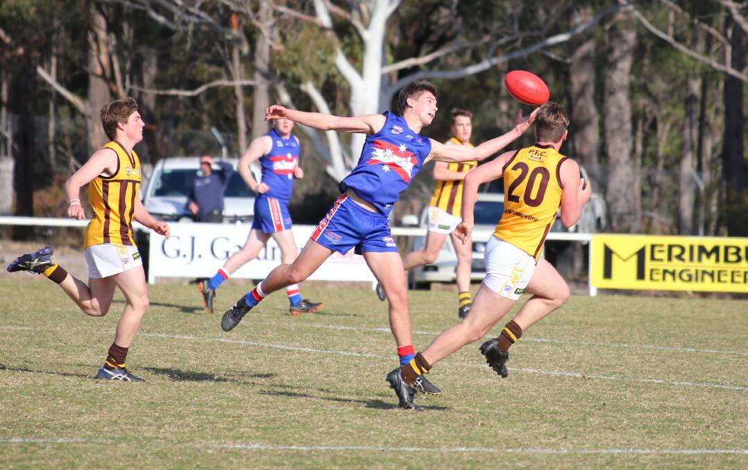 Feathery touch: A Merimbula Digger takes a mark on his fingertips during the club's narrow win over Pambula on Saturday for a grand final place. 