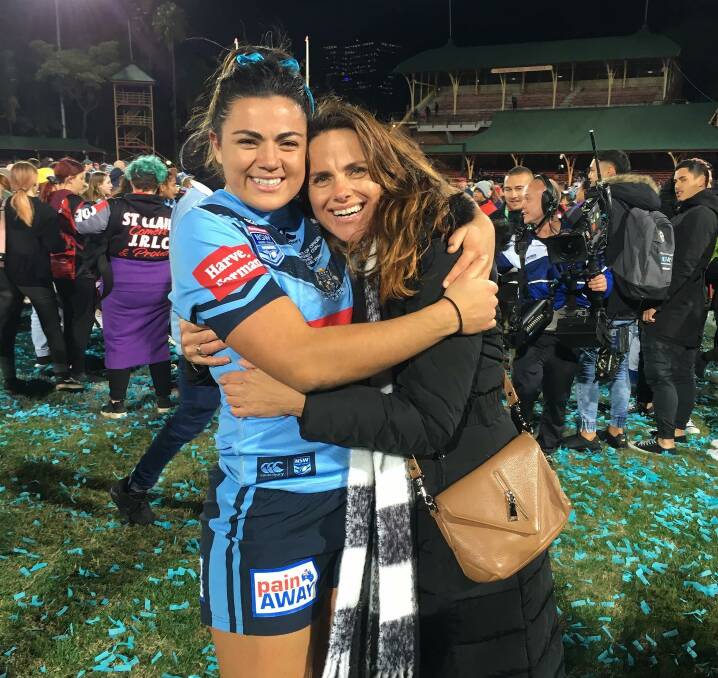 Cross code star: Millie Boyle shares a hug with her proud mum Shelley Boyle following the Blues' 14-4 win over Queensland in front nearly 11,000 people on Friday.