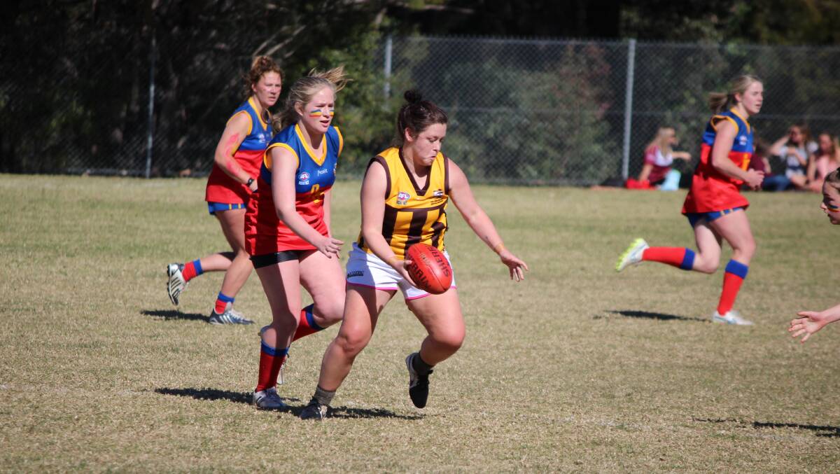 Strong display: Britt Salt shapes to kick out of the midfield after besting her Narooma opponent during Saturday's minor semi-final. 