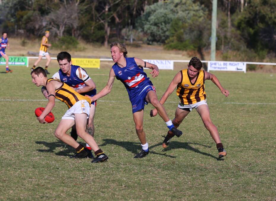 Local derby: Merimbula players close in to tackle the Pambula ball carrier during Saturday's tight contest, which was decided by three points. 