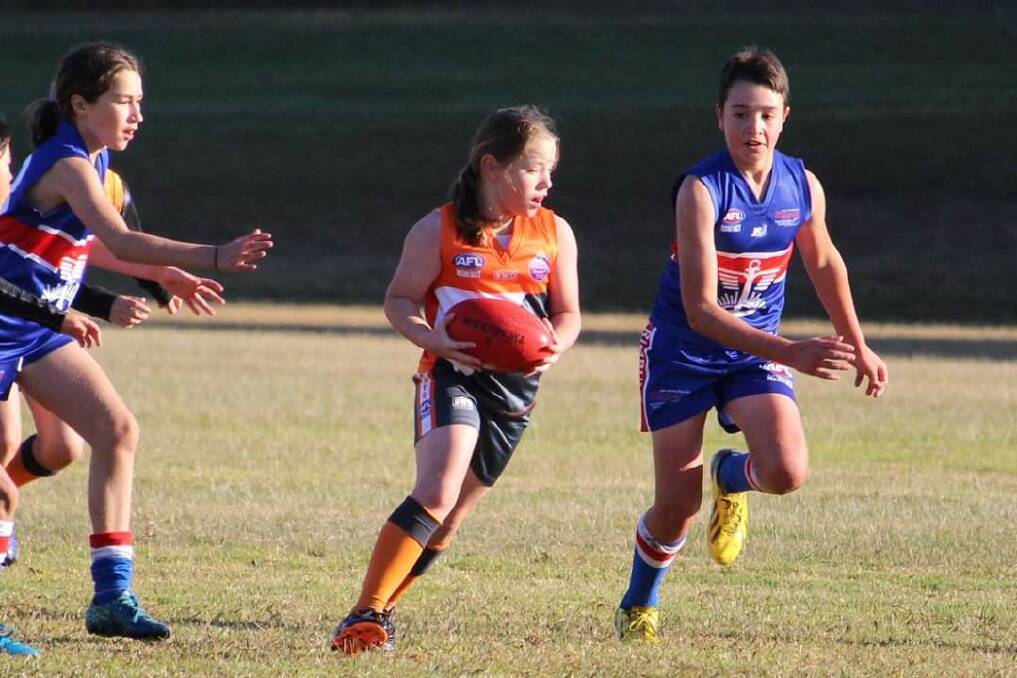 New generation: Players from the Broulee/Moruya Giants and the Merimbula Diggers battle for the ball during a junior clash last season. Picture: supplied. 