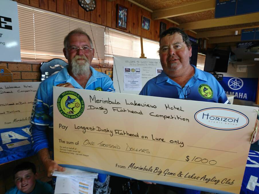Comp winner: Lindon Thompson presents the $1000 cheque to David Huntley of Millingandi for his competition winning dusky flathead. 