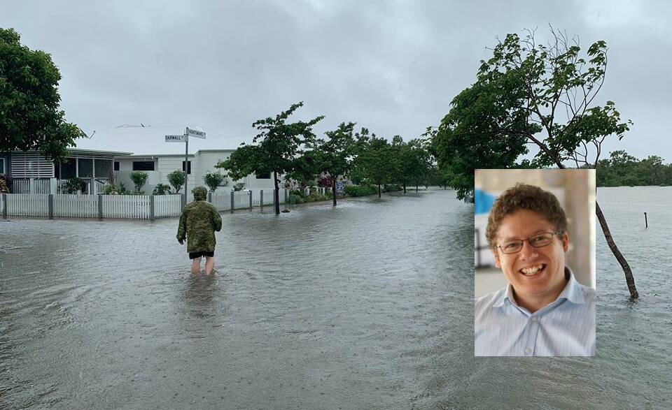SCARY STORM: Former Pambula chef Cato Bailey walks through flood waters near his Greater Ascot home in Townsville on Monday. 