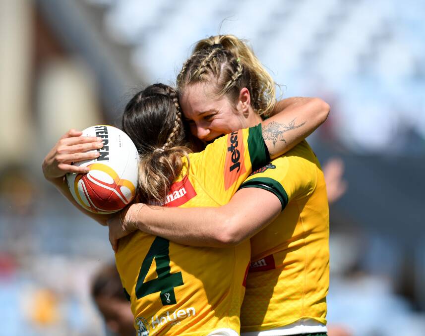 Cheering: Kezie Apps shares an embrace with a team-mate as Australia locked in a World Cup finals berth, dominating Canada on Sunday. Picture: NRL PHOTOS