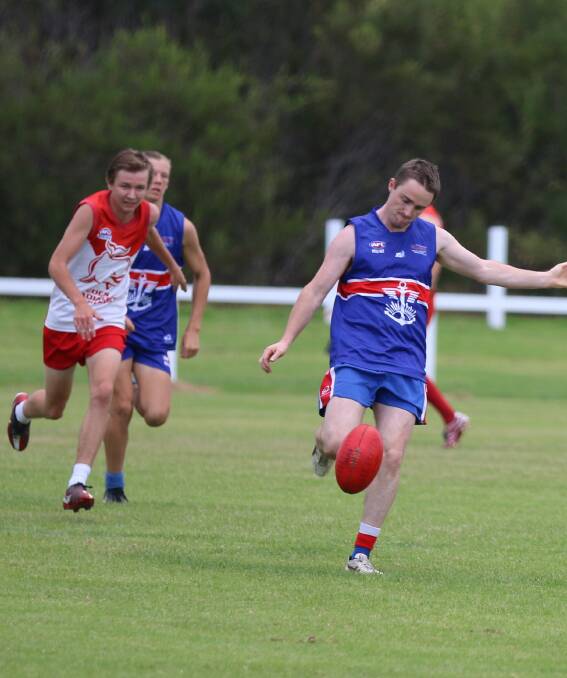 You're hot: Digger Brendon Gordon fires a kick up the field to a team-mate as the Eden Whalers close in on Saturday. 