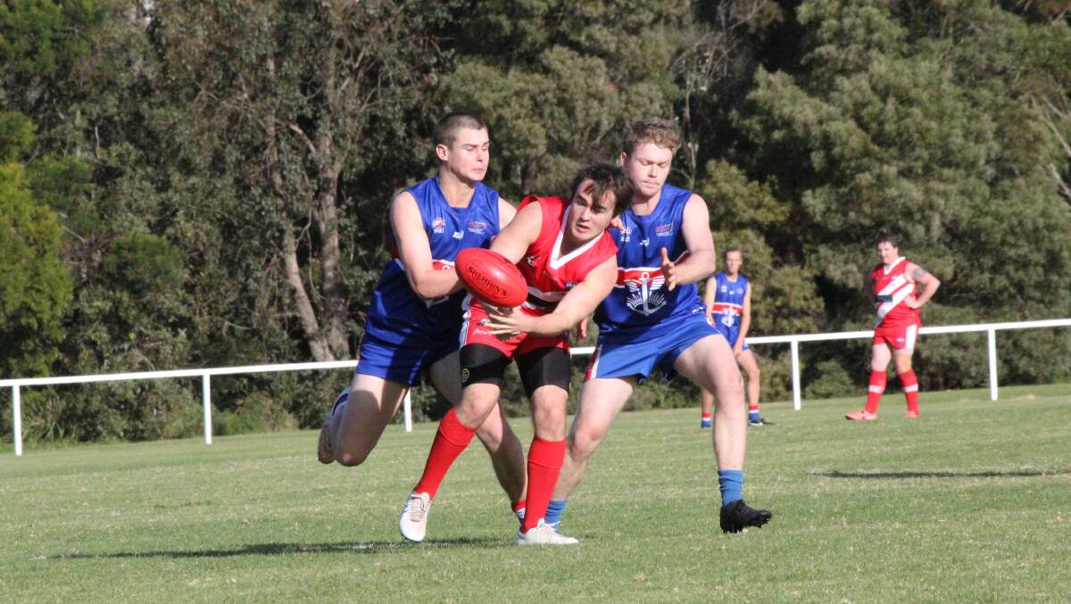 Incoming tackle: Two Diggers combine in a tackle on their Eden opponent during the Merimbula club's 100-point win on Saturday. Picture: Zach Hubber