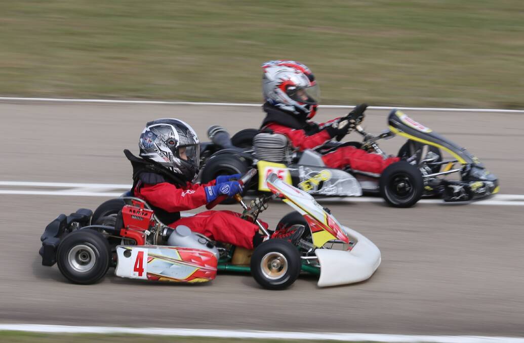 Passing move: Luca Rucinski is overtaken by Aidan Williams during one of the Cadet 9 heats at the Sapphire Coast Kart Club's Sapphire Cup. 