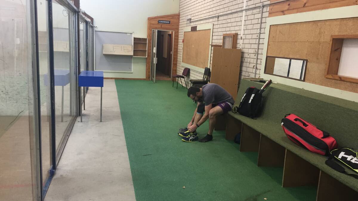 Lacing up: Alex Wakeford ties up his shoes for the last games ever to be played on the existing Merimbula squash courts. 