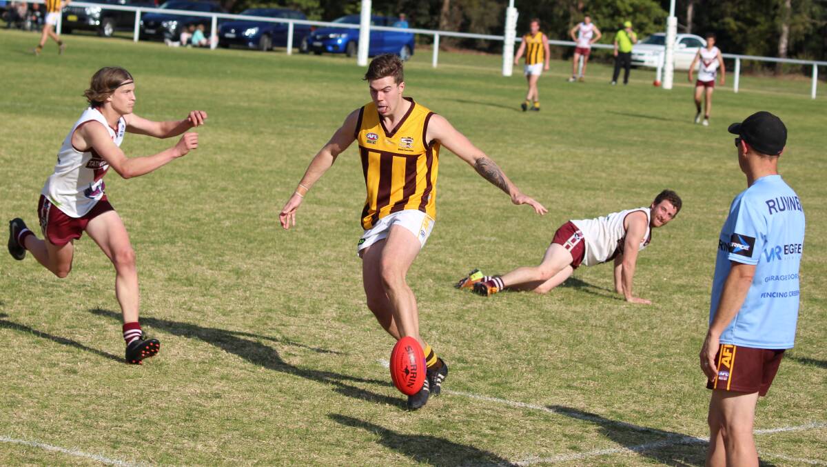 Momentum: Panther Jake Taylor gets a kick forward after evading a Tathra tackle attempt during Saturday's win in the preliminary final. 