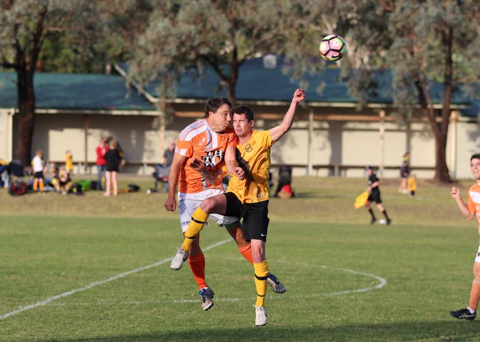 Head knock: Pambula veteran Pat Wilson and a Wolumla forward suffered a nasty clash while going for a header on Sunday. 