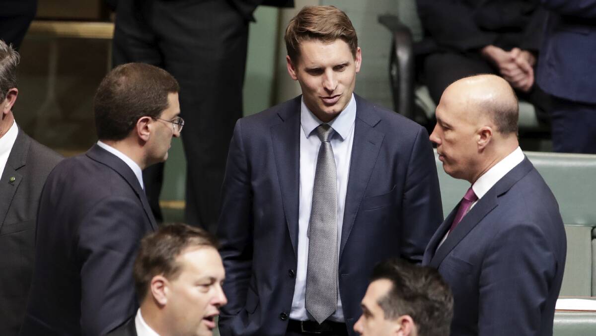 Minister for Home Affairs Peter Dutton (right) speaks with Julian Leeser and Andrew Hastie from the Parliamentary Joint Committee on Intelligence and Security on July 24. Picture: Alex Ellinghausen