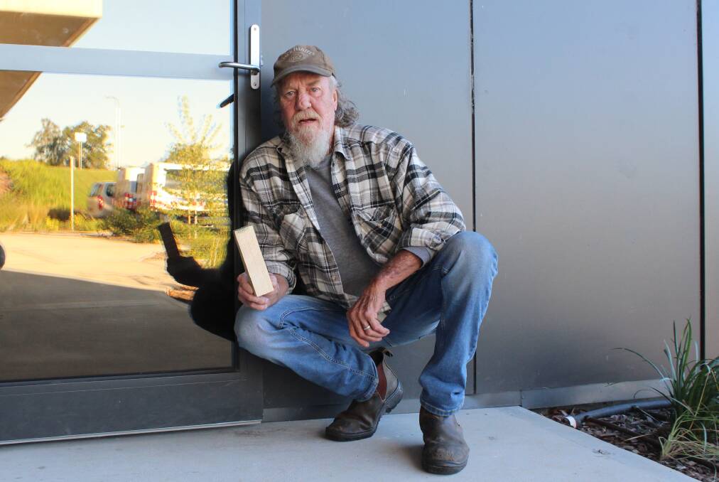 WEDGED: Wayne Longford with his wedge outside the renal dialysis unit entrance at South East Regional Hospital.