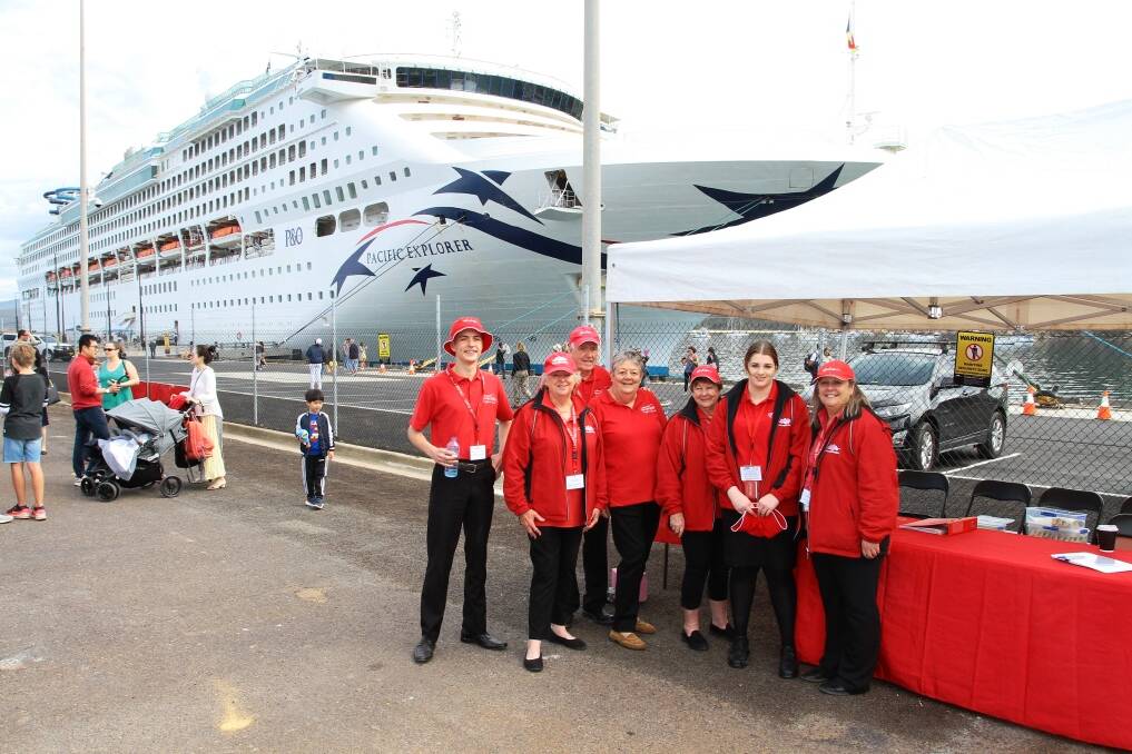 P&O Cruises Australia flagship Pacific Explorer two years ago as it became the first cruise ship to visit Eden to use the new wharf extension and seen here with Cruise Eden volunteers. Photo supplied