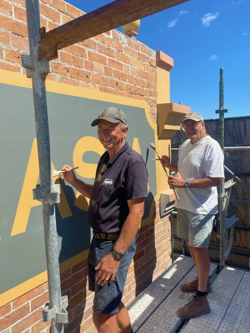 Family-owned business Wilson's Signs from Pambula painting the name back on to the side of the Australasia. Photo: Neil Rankin
