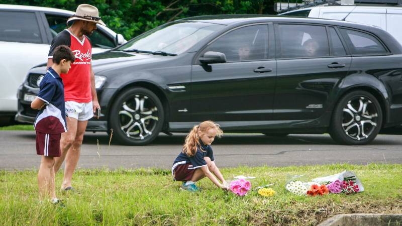 Mourners leave flowers at Riley Park in Unanderra. Photo: Georgia Matts
