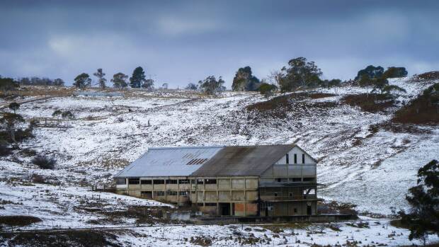 The old Bombala Railway line passes the derelict Maclaughlin Meat Works, photographed after a light snow fall. Photo: Judy Goggin

