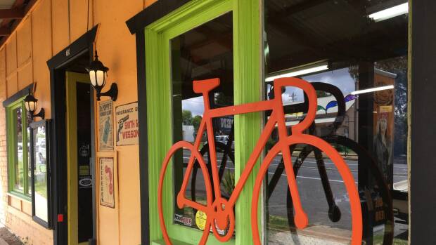 One of the many orange bike cut-outs appearing in shop windows around the region in support of the Monaro Rail Trail. Photo: Tim the Yowie Man

