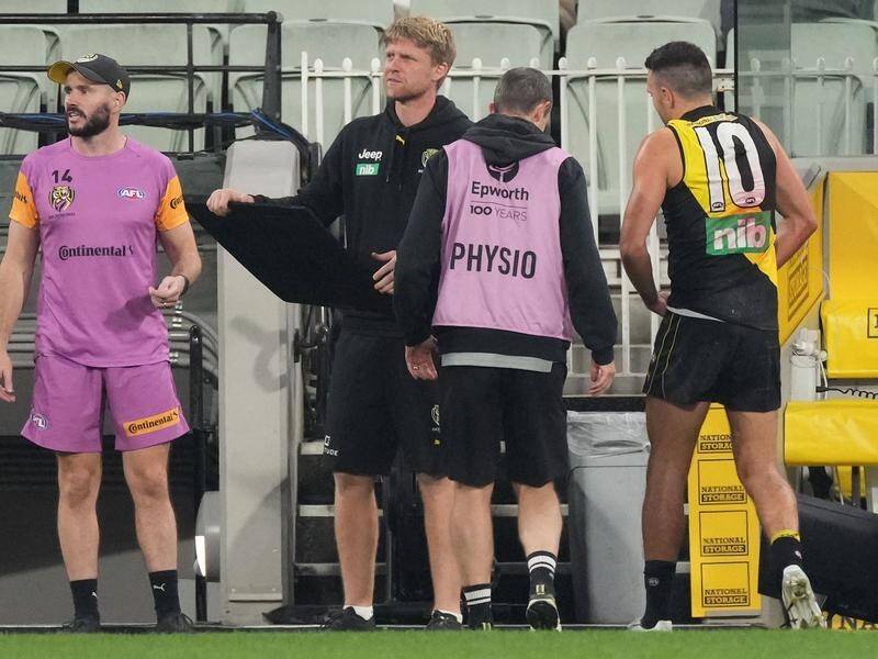 Richmond's Shane Edwards leaving the field injured during their defeat by Geelong.